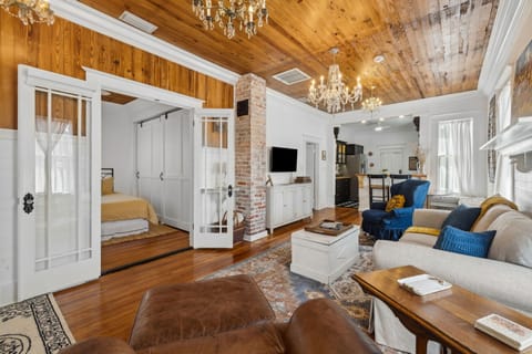 Two person sofa, 2x accent chairs, Smart TV. Guest bedroom is located next to the living room.