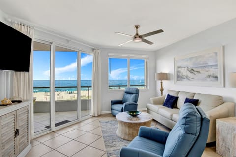 Living Room with BEAUTIFUL Gulf view, balcony access, wall mounted Smart TV, leather sleeper sofa and 2 leather recliners