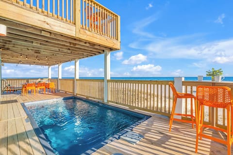 Lounge in the private pool, with an expansive view of the beach & crashing waves