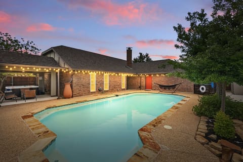 What amenity does this backyard not have?! Whether you’re looking to relax in the poolside hammock or enjoy a refreshing swim, this is a backyard pool paradise!
