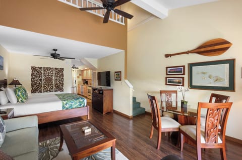 Your open-concept retreat features vaulted ceilings, tropical décor, and a seamless flow from the cozy sleeping area to the dining space and kitchenette—ideal for unwinding after island adventures.