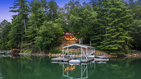 Peaceful evenings: illuminated dock, glowing home.