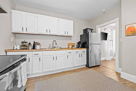A bright and clean kitchen designed with efficiency and style in mind. The sleek appliances and white cabinets provide a timeless appeal.