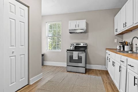 The entryway opens to a spacious and inviting kitchen area. Clean lines and neutral tones make the space feel fresh and organized.