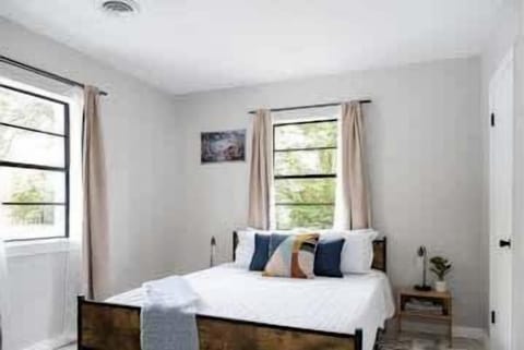 A cozy bedroom with a queen bed, soft linens, and decorative touches for a restful retreat.