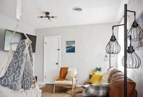 A small, inviting reading or work nook with a chair, soft lighting, and rustic accents.