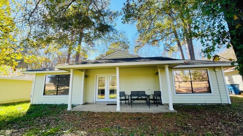 Covered and furnished patio with a golf course view.