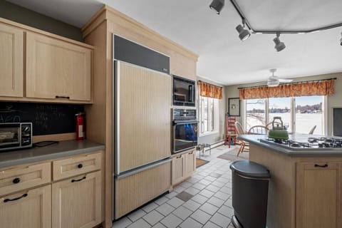 Bright and spacious kitchen featuring modern appliances, lake views, and everything you need for family meals.