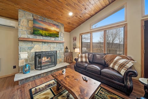 Stacked-Stone Gas Fireplace in the Living Room with Mounted TV