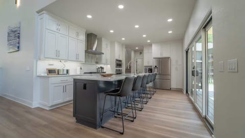 Cook like a pro in the chef’s kitchen with double ovens, multiple coffee makers, and pantry staples.