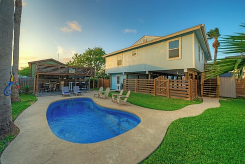 Private pool with shaded outdoor lounge.