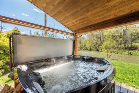 Riverside hot tub with steamy view where you will enjoy listening to the creek while having a relaxing evening