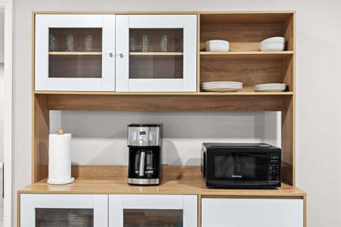 Kitchen: Start your day right with a hot cup of coffee or heat up leftovers with ease—everything you need is right here.