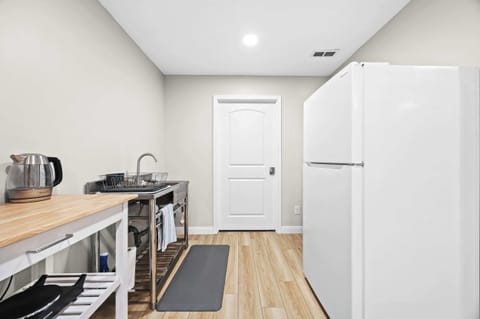 Kitchen: A bright, minimalist kitchen space with everything you need to cook, prep, and store your meals.