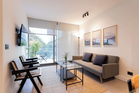 Experience modern comfort in this stylish living room, featuring large windows and a serene view. Perfect for relaxation and unwinding.