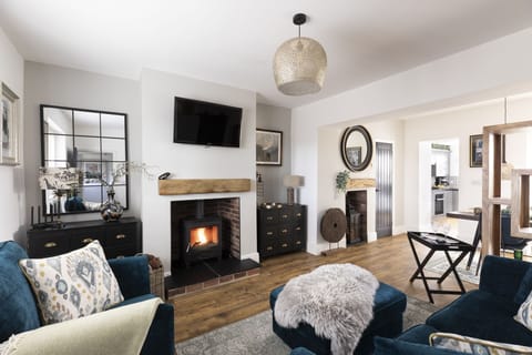 Pigswood Cottage - the log burner and seating in the living area