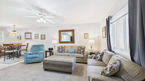 Open concept living area with TV and sleeper sofa