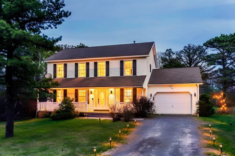 Stunning view of the entire house at night, beautifully lit with ambient night lights, creating a warm and inviting atmosphere.