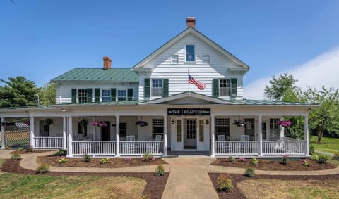 Historic inn with a spacious wraparound porch and rocking chairs for relaxing outdoors