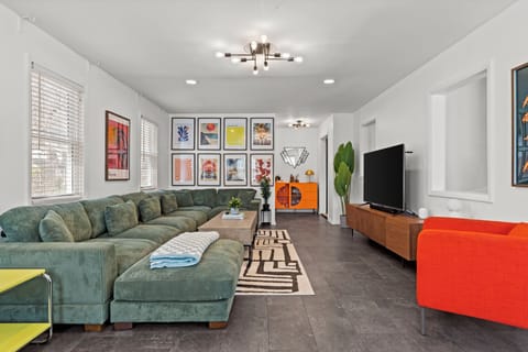 Spacious modern living room with an oversized sectional perfect for groups, movie nights, and relaxing together