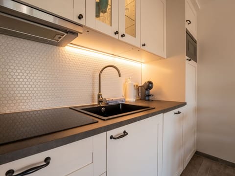 Kitchen, Countertop, Interior Design, Cabinetry, Plumbing Fixture, Tap, Kitchen Sink, Sink, Lighting, Flooring