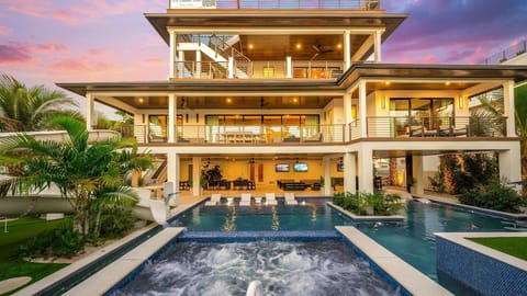 Twilight - Rear Elevation - Deep Blue Sea - Resort Style Pool w/ 60ft Waterslide, Swim-Up Bar Top, Spa, and Rain Curtain