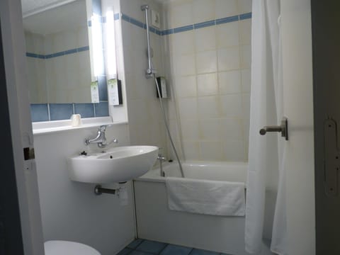 Bathtub, eco-friendly toiletries, hair dryer, towels
