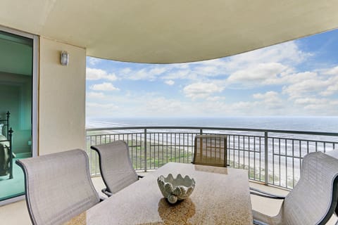 This spacious beachfront balcony offers panoramic Gulf views, comfortable seating, and a perfect setting for dining al fresco or simply enjoying the breeze.