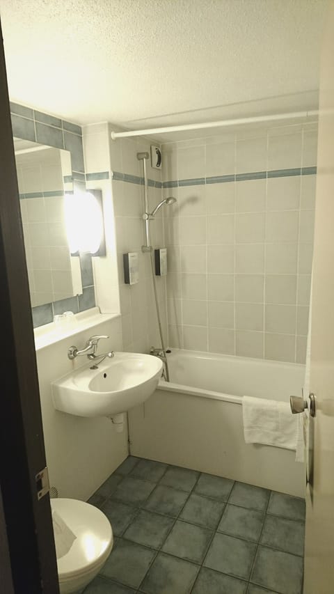 Bathtub, eco-friendly toiletries, hair dryer, towels