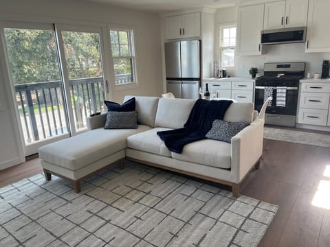 Living room with walk out deck, full kitchen with all amenities
