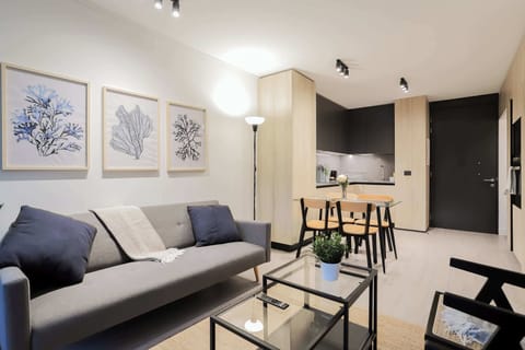Modern living space with sleek kitchen and stylish decor, perfect for relaxing or entertaining in comfort.
