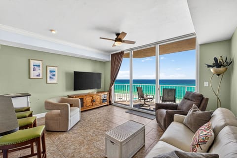 Relax in this coastal living room with ocean views and direct balcony access.