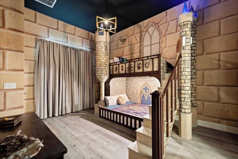 Step into a fairytale castle room with grand décor and whimsical sleeping loft
