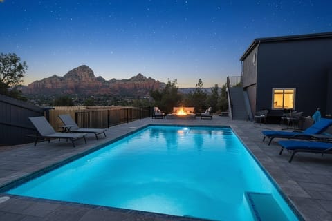 Huge heated pool and lounger deck with Thunder Mountain red rock views.