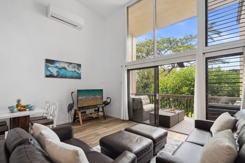 Spacious living room with high ceilings, a smart TV, and direct access to the lanai.