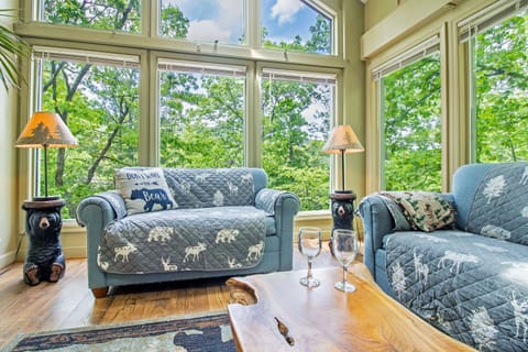Living area with expansive windows, television, and comfortable seating 