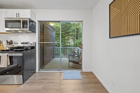 Step out of the modern kitchen through a set of glass doors opens directly to the inviting patio, seamlessly blending indoor comfort with outdoor relaxation.