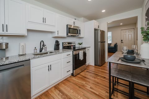 Contemporary kitchen setup with bar seating for casual meals or morning coffee.