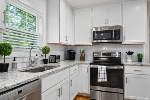 A modern kitchen equipped with stainless steel appliances, ample cabinetry, and a large island, ideal for meal preparation and casual dining.