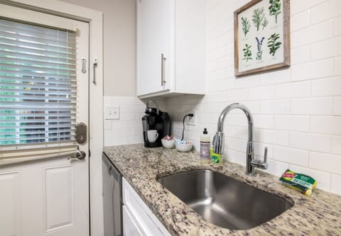 Coffee station and sink area with a Keurig, mugs, and hand soap—everything you need to start your day righ