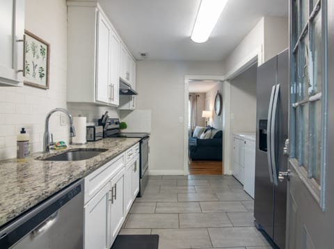 Modern galley kitchen with sleek countertops, full-size appliances, and a clean, practical layout