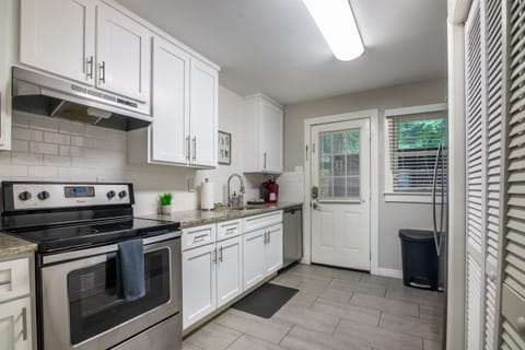 Fully stocked kitchen with stainless steel appliances, ample cabinetry, and everything you need for home-cooked meals.