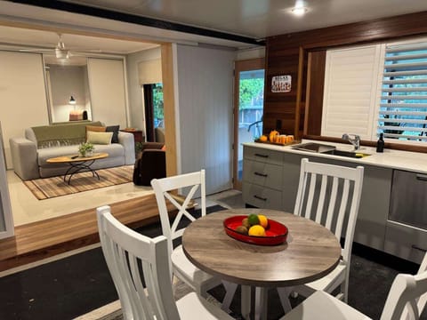 Full kitchen, kitchen dining table for 4 - move to the spacious deck outside for 8 seater dining. Sofa, single chair, 65 inch smart TV.