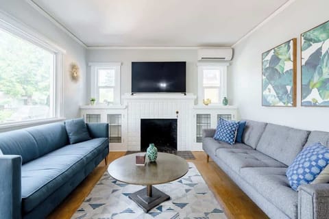Main house living room with fireplace and TV.