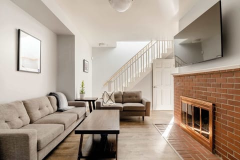 Living room with sofa and fireplace.