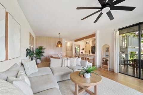 Relax in the stylish living room with large section, smart TV and island decor.