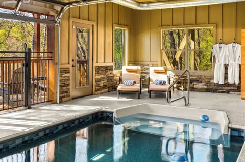 Indoor Pool Oasis: Dive into relaxation with tranquil views and luxurious lounge chairs!