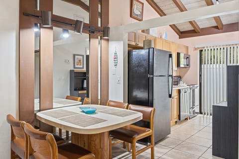 The kitchenette includes a refrigerator, cabinetry, and nearby dining space for simple meals during your stay.