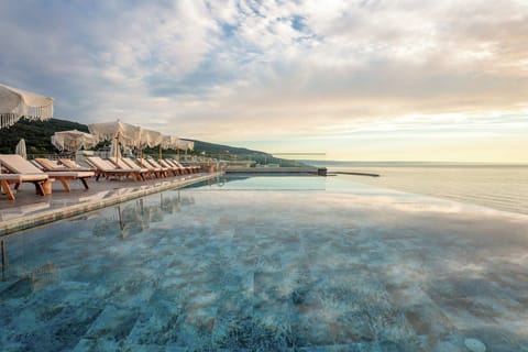 Indoor pool, outdoor pool, open 9 AM to 6 PM, pool umbrellas