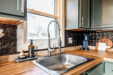 Our kitchen features a spacious farmhouse sink beneath a window overlooking the fenced backyard. For a seamless stay, we provide starter essentials like hand soap, dish soap, dishwasher pods, garbage bags, and Keurig Pods to get you started!